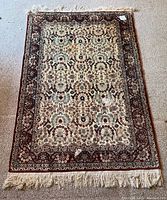Full view of the Persian carpet showing the overall pattern and fringe.