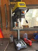 Front view of Ryobi bench top drill press showing base, column and head