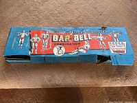 Closed vintage Whitely New Progressive Bar Bell Combination box with original graphics and text.