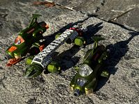 Photo of three vintage green Dinky Toys including two UFO Interceptor vehicles and a large space station model in daylight on stone surface.