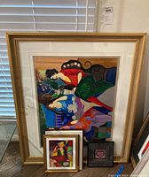 Four framed color serigraph prints by Linda Le Kniff and Itzchak Tarkay displayed together, showing three smaller prints layered in front of a large print.
