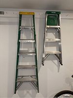 Front view of 6-foot Davidson ladder and 4-foot Werner ladder hanging on wall, showing overall condition and size comparison.