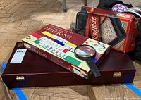 Mahjong set box, Scrabble game box, magnifying glass on top of closed wooden case