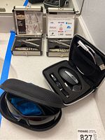 Overview of all items: two Sheffield mini tool boxes, carrying case with light and charger kit, Costa sunglasses in zippered case.