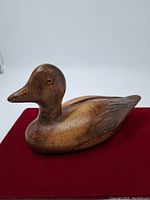 Front and side view of wood duck showing painted eyes, smooth finish, and carved body detail