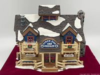 Front view of the Birch Run Ski Chalet model showing signs 'Refreshments' and 'Ski Lessons' and snow on roof.