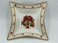 Top view of square Limoges dish showing central bell and ribbon design with decorative border and gold trim.