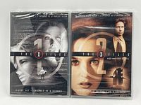 Front view of The X Files Season 1 and Season 2 DVD box sets in shrink wrap showing cover art and disc count