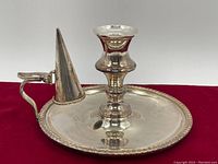 Front angle showing the full candle holder with base, handle, and conical candle snuffer cone.