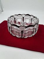 Photo showing the exterior side of the crystal bowl, highlighting the scalloped rim and etched fan patterns.