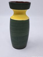 Front view of the vase showing green body with yellow neck and wide rim