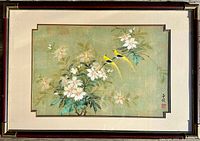 Full frontal image of the framed Chinese watercolor painting depicting white flowers and two yellow birds on cork paper with silk matting and brass cornered wooden frame.