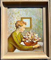 Framed oil on board painting showing a side-profile of a seated woman leaning on a table holding a bowl of stylized flowers