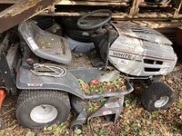 Side view of entire tractor showing seat, steering wheel, tires and mower deck