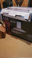 CTM branded stove vent hood box showing front panel with 450 CFM air flow and stainless steel finish mentioned.