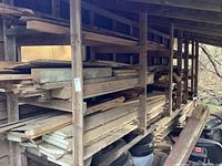 Wide view of shelves filled with assorted wood off cuts stored horizontally in a wooden rack.