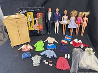 Full lot showing dolls, various outfits, Barbie closet, and accessories