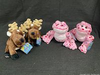 Four Webkinz plush toys: two reindeer and two love frogs, all tagged and new.