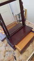 Full view of the wooden dresser vanity top with mirror and drawer open, showing overall condition and design.