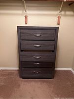 Front view of the dresser showing all five drawers with metal handles