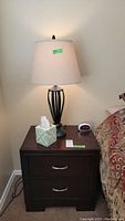 Nightstand with lamp on top, showing overall appearance and size.