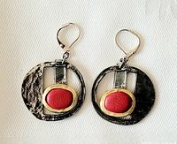 Front view of the pewter dangle earrings showing hammered texture and red accent.