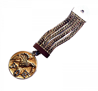 Front view of circular gold-filled locket pendant with detailed eagle and "FOE 47" rhinestone letters attached to multi-strand gold chain band.