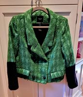 Front view of green textured wool blend Smythe jacket with black cuffs and button closure on a hanger.