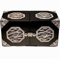 Closed view of the black folding jewelry box showing the mother of pearl inlay decorations on the top and front panels, with a butterfly-shaped clasp in the center.