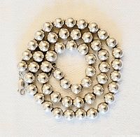 Coiled necklace showing bead arrangement and clasp.