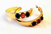 Pair of 18K gold plated hoop earrings with three genuine stones each: gray aventurine, carnelian, and lapis lazuli in front; photographed on white background to show overall design.