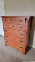 Full view of JC Penney mission style wood grain dresser showing five drawers with metal drop ring handles, two handles broken on the top drawers.