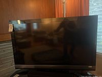 Full front view of the 46-inch Sony Bravia TV powered off showing the bezel and screen.