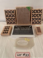 Front view of five wooden stamps with geometric patterns arranged behind two archival ink pads.