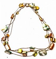 Full view of vintage single strand necklace with mother of pearl beads in multiple natural pastel colors laid flat showing overall design.