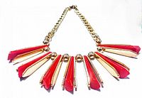 Full view of vintage gold-tone chain necklace with red and gold triangular accents arranged symmetrically.