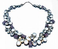 Front view of the vintage signed necklace showcasing clear round and oval beads with purple rectangular beads.