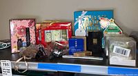 Wide image showing various bath and shower gift sets on a shelf, including boxes and small unopened packages.