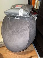 One grey corduroy bean bag chair with sealed charcoal chenille replacement cover on top