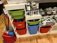 Front view of the IKEA TROFAST storage unit with bins filled with small items and toys.