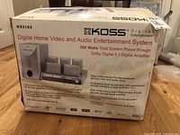 Full view of Koss Digital Home Video and Audio Entertainment System KS3102 box with product image and details including 500 watts total power and Dolby Digital 5.1 amplifier.