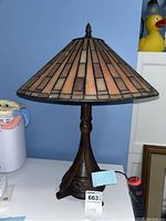 Full view of the lamp showing the metal base and stained glass Tiffany-style shade.