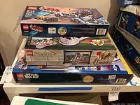 Three LEGO set boxes stacked: Movie, Kingdoms Chess, Star Wars