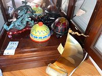 Photo of all four items including metal dragon sculpture, turtle lamp, ceramic dish, and boat decor
