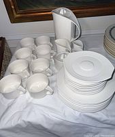Full view of the set including cups, plates, saucers, pitcher, creamer, and sugar bowl.