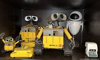 Photo showing the main WALL·E robotic toys, EVE figure and mini WALL·E characters placed on a shelf.