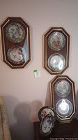 Three double-plate octagonal frames with hummingbird plates and two plates on stands below.