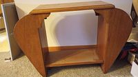 Front view showing bowed end legs, lower shelf, and top surface