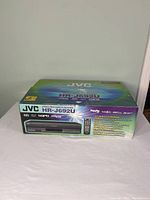 Original closed retail box of the JVC HR-J692U VHS stereo video cassette recorder with front product image and branding.