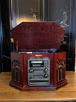 Memorex stereo console closed with lid up showing wood grain finish, control panel with radio tuning, buttons and knobs